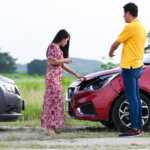 Automobile Accident with red and grey car and two person