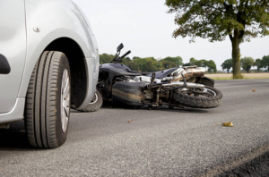 motorcycle accident with car on road